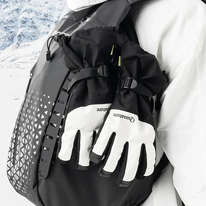 Person wearing black gloves and a backpack with a scenic background